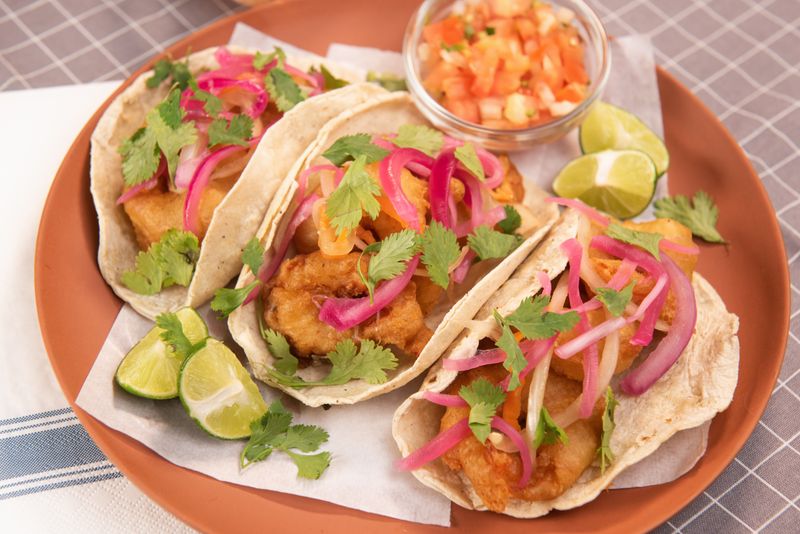 Crispy fish tacos with lime slaw at Guzman y Gomez